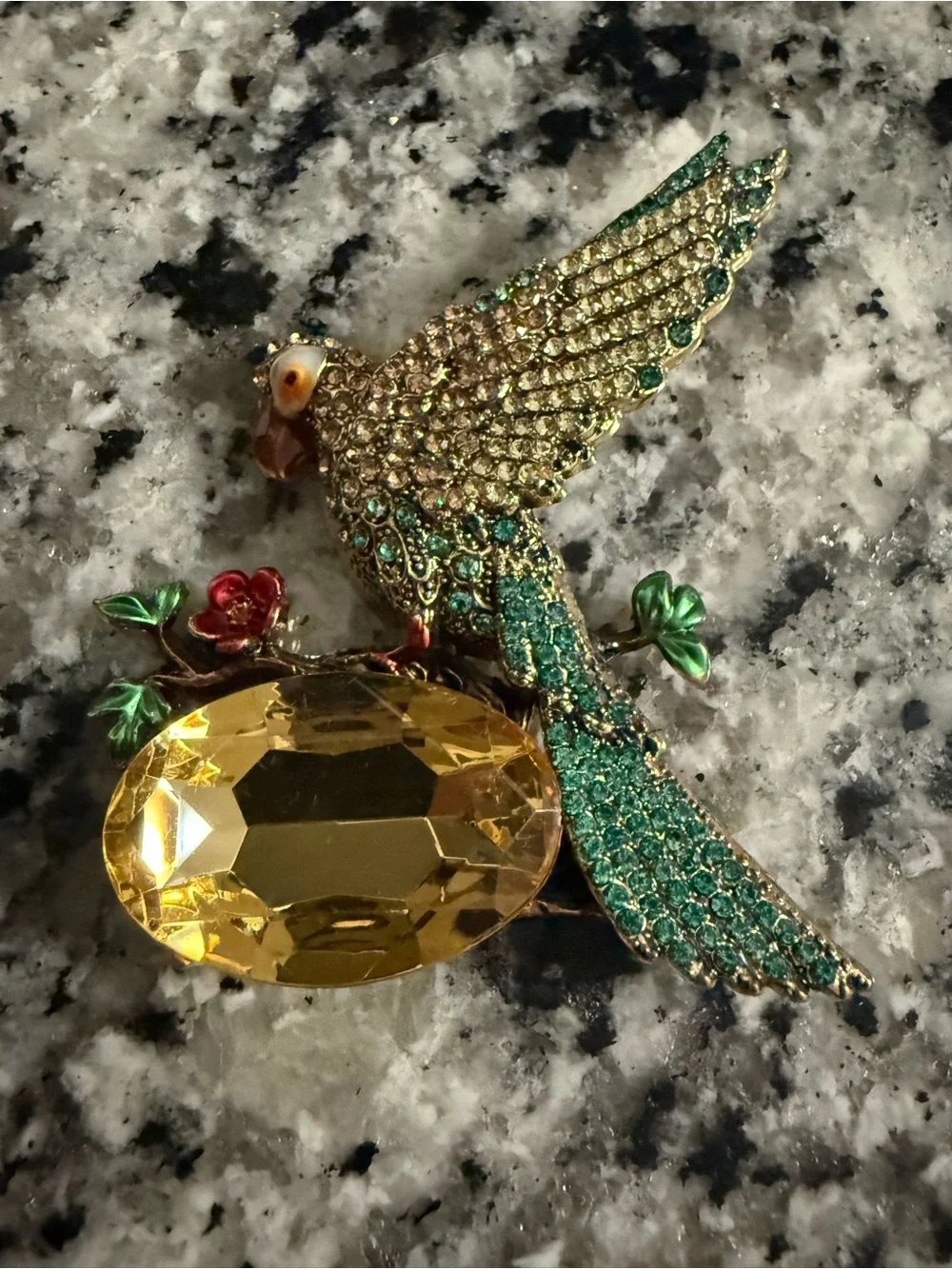 vintage-inspired green crystal parrot brooch with yellow stone